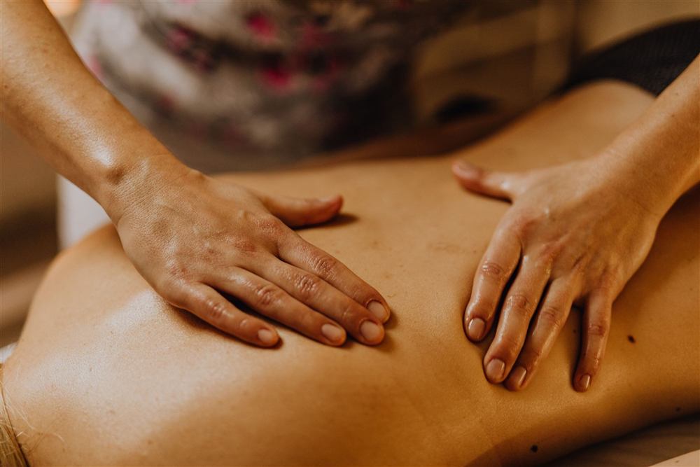 Physiotherapist providing hands-on manual treatment to a patient's back
