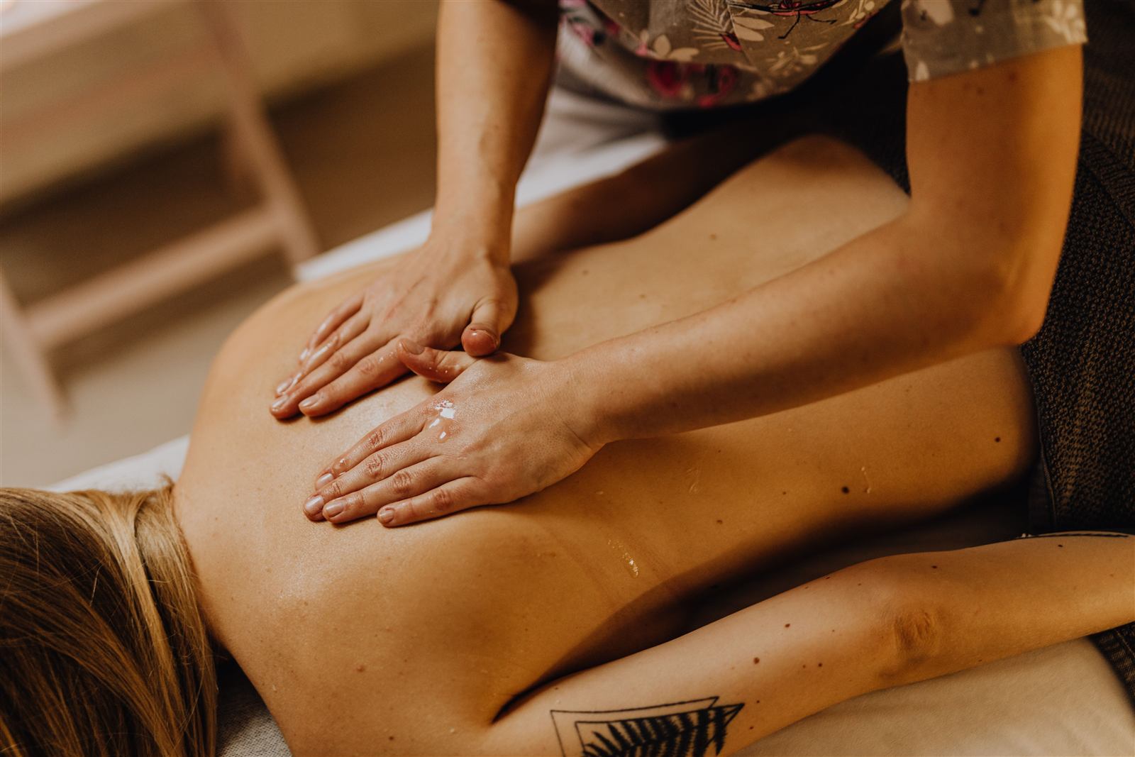 Hands-on treatment being applied to a patient's back, reflecting a collaborative approach to rehabilitation