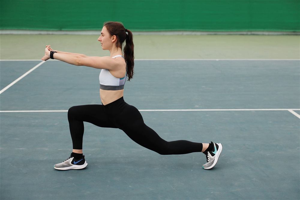 Patient stretching and moving through a guided rehabilitation exercise